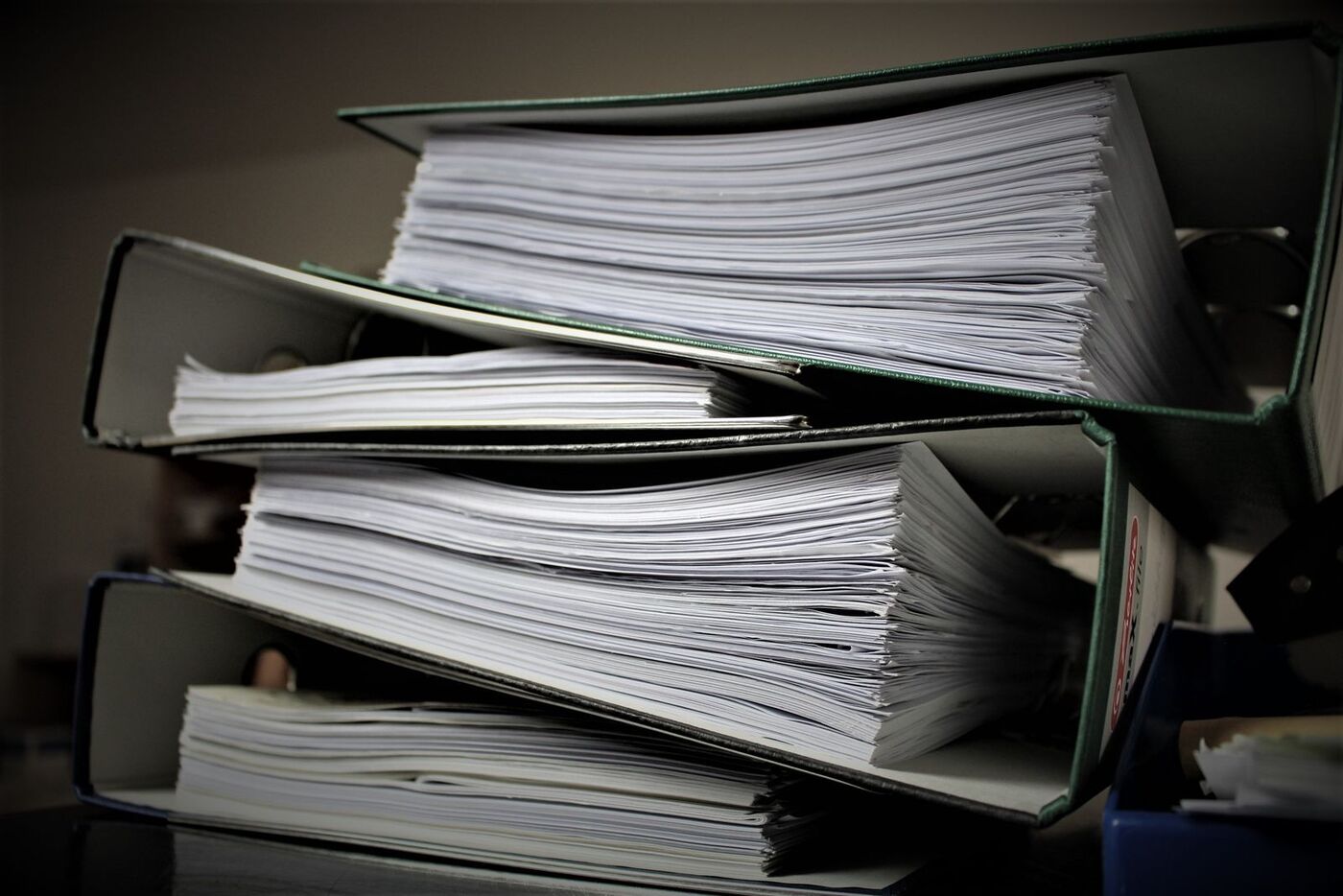 Stacked binders filled with documents